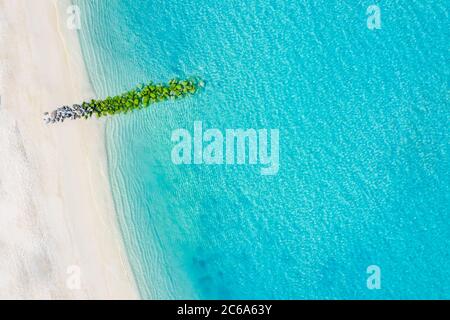 Sand beach aerial, top view of a beautiful sandy beach aerial shot with the blue waves rolling into the shore, some rocks present Stock Photo