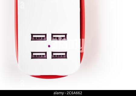 Extension Socket with USB Port on white background for charging phones and electronic devices, red power cord. Stock Photo