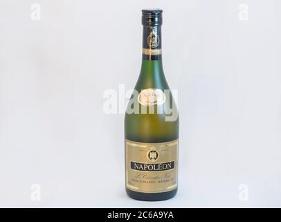 KIEV, UKRAINE - FEBRUARY 17, 2019: French pure grape V.S.O.P. brandy Napoleon old bottle closeup against white background. Stock Photo