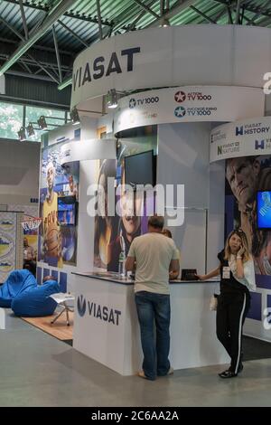 KYIV, UKRAINE - MAY 21, 2015: People visit Viasat, satellite and pay television brand booth on TV and Radio International Fair in ACCO EC, main busine Stock Photo