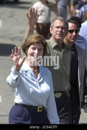 Belton, Texas USA, July 4 2000: Texas Governor and U.S. presidential candidate George W. Bush and wife Laura, accompanied by heavy security, walk the parade route of the Bell County Independence Day parade in downtown Belton.  The Bushes spent the holiday weekend at their nearby ranch pondering vice-presidential selections.  ©Bob Daemmrich Stock Photo
