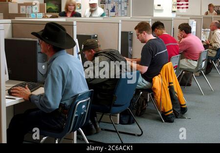 Austin Texas USA, January 16 2002: Job-seekers work on computers in individual cubicles at the Capital of Texas Workforce Commission as they look online for works. ©Bob Daemmrich Stock Photo