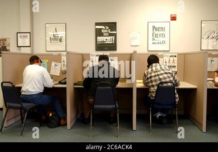 Austin Texas USA, January 16, 2002: Job seekers work the phones at Capital of Texas Workforce Commission offices.  ©Bob Daemmrich Stock Photo