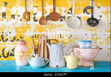 various vintage tableware and kitchen utensils on grungy background
