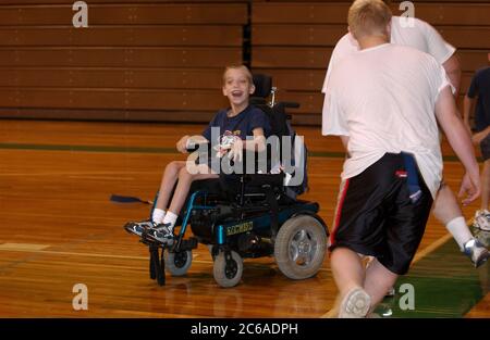 Mabank, Texas USA, September 10, 2003: 12-year-old boy with cerebral palsy and learning disability plays 'flag tag' in gym class, mainstreamed with other children. MODEL RELEASE SP-71 (boy in wheelchair). Others not released.  ©Bob Daemmrich Stock Photo