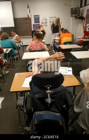 Mabank, Texas USA, September 10, 2003:  Wheelchair-bound 12-year-old boy with cerebral palsy, mainstreamed into his seventh-grade class, raises his hand during math lesson.  MODEL RELEASE SP71 ©Bob Daemmrich Stock Photo