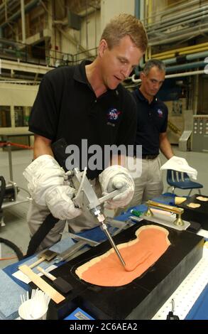 Houston Texas USA, September 16, 2003: During a press tour at the Johnson Space Center, NASA astronaut Scott Parazynski, who will fly on an upcoming space shuttle mission, shows how tile filler material will be used to fill holes in space shuttle tiles by astronauts doing repair mission. NASA is preparing for the return to flight of the Space Shuttle program in 2004, following the loss of the Columbia shuttle on Feb. 1.  ©Bob Daemmrich Stock Photo