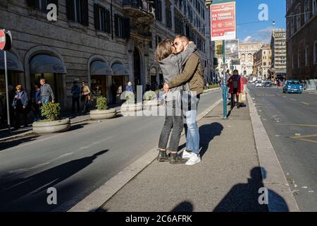 Lovers kissing in the middle of a street in Rome, Italy Stock Photo