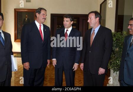 Mexico City DF, Mexico, June, 2004: During a trade mission to Mexico City, Texas Governor Rick Perry meets with Mexico President Vincente Fox (left).  U.S. Ambassador Tony Garza is at right. ©Bob Daemmrich Stock Photo