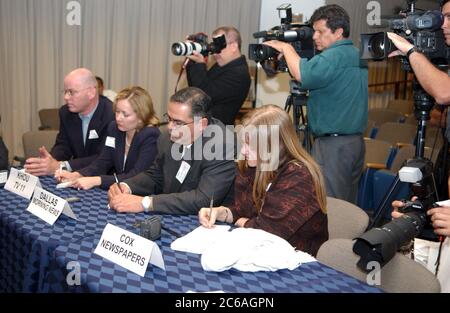 Press conference, journalists taking notes, holding microphone and ...