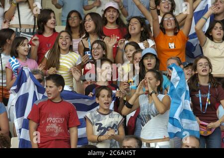 Athens, Greece, September 23 2004: Greek schoolchildren cheer the track athletes at a morning session of the Paralympic Games. Students in Athens got a week off from school to watch the historic events at Olympic Stadium.  ©Bob Daemmrich Stock Photo