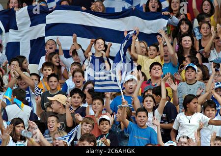 Athens, Greece, September 23 2004: Greek schoolchildren cheer the track athletes at a morning session of the Paralympic Games. Students in Athens got a week off from school to watch the historic events at Olympic Stadium.  ©Bob Daemmrich Stock Photo