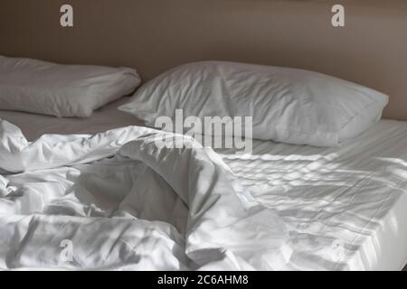 White mattress in the morning with the light lay on the bed. Stock Photo