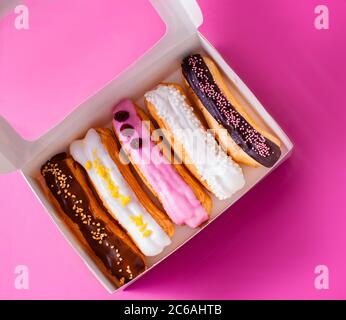 Festive set of delicious eclairs with different fillings Stock Photo