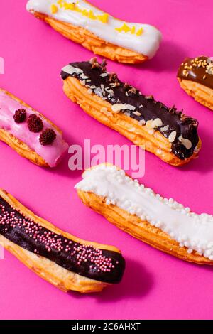 Several eclairs with different colored types of fillings Stock Photo