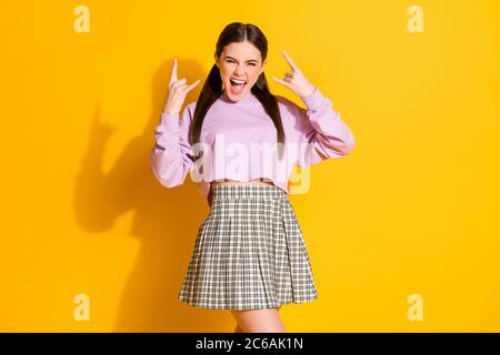 Portrait of her she nice attractive cool comic funky cheerful cheery naughty girl having fun showing horn sign isolated over bright vivid shine Stock Photo