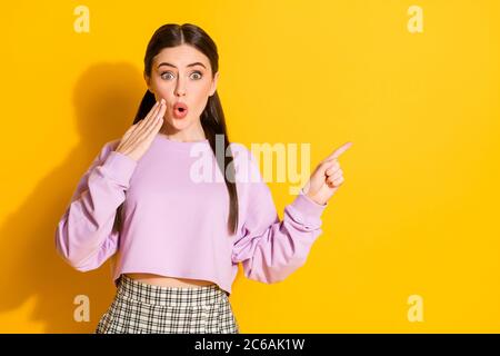 Portrait of astonished youth girl point index finger copyspace indicate incredible advert promo impressed scream wow omg wear outfit isolated over Stock Photo