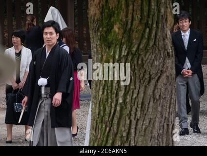 Japanese groom in black kimono at Meiji Jingu Shinto shrine compound, Tokyo, Japan Stock Photo