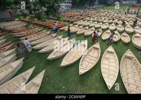 Ghior, Manikgan, Bangladesh. 8th July, 2020. Hand-made wooden boats are displayed for sale at a market in Ghior, Manikgan, Bangladesh, on July 08, 2020. The demand for various types of small-sized boats has gone up here with the rise in water level in different rivers and subsequent flooding. The demand for Dingi and Khosa Nauka (small boat) has increased for regular movement of people in flood-prone areas here. Credit: Suvra Kanti Das/ZUMA Wire/Alamy Live News Stock Photo