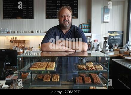 Owner Toby Chapman poses for a photograph inside his deli, Deli on the Quay, in Poole, Dorset, after as the Chancellor announced his bid to encourage people to eat out with a VAT cut from 20% to 5% in the hospitality sector and an 'Eat Out to Help Out' discount. Half price meals will be offered to diners eating out every Monday, Tuesday and Wednesday during August at participating restaurants across the UK. Stock Photo