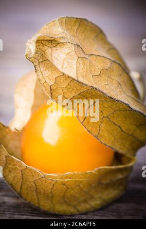 Physalis, or Cape Gooseberry fruit over old wood background. Vintage ...