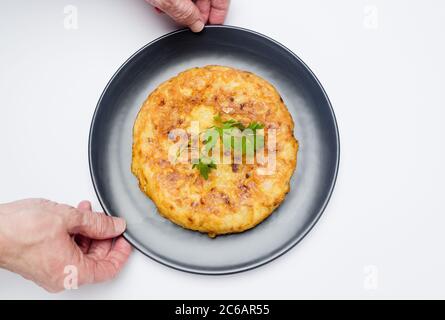 The Spanish omelette, potato omelette or Spanish omelette - also called potato omelette in Latin America, the Canary Islands or Andalusia - is an omel Stock Photo