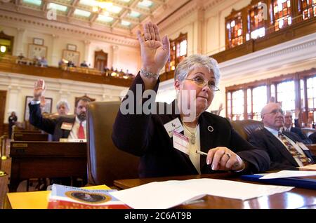 Austin, Texas USA, December 13, 2004 : Marjorie Chandler, a presidential elector from Texas, casts her vote for Republican George W. Bush in the Meeting of the Presidential Electors, commonly known as the Electoral College, at the Texas state Capitol. ©Bob Daemmrich Stock Photo
