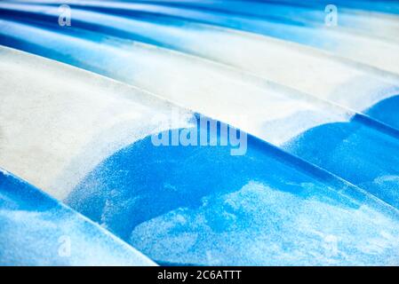Colourful kayaks stacked up for hire at the beach Stock Photo