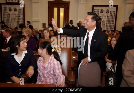 Austin Texas USA, January 11 2005: Hubert Vo, the first Vietnamese-American elected to the Texas legislature, with his wife and daughter on opening day of his first legislative session inside the House of Representatives chamber at the Texas Capitol. ©Bob Daemmrich Stock Photo