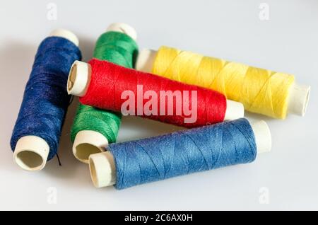 Colorful spools of yarn on white background Stock Photo