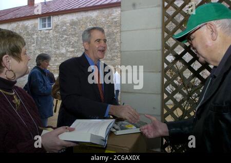 Fredericksburg, Texas USA, February 19 F2005: Retired Marine Lt. Col. Oliver North shakes hands with a spectator during a parade of World War II era military vehicles commemorating the 60th anniversary of the WWII battle for Iwo Jima. ©Bob Daemmrich Stock Photo