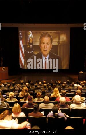 College Station, Texas USA, March 11 2005: During a naturalization ceremony for 50 soldiers sworn in as new U.S. citizens at the George H.W. Bush Presidential Library. U.S. President George W. Bush appears via satellite uplink to the new citizens. ©Bob Daemmrich Stock Photo