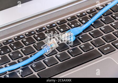 Two internet cable on computer keyboard Stock Photo