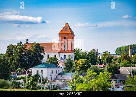Old medieval building against the blue sky. Ancient architecture. House with red roof tiles. Stock Photo