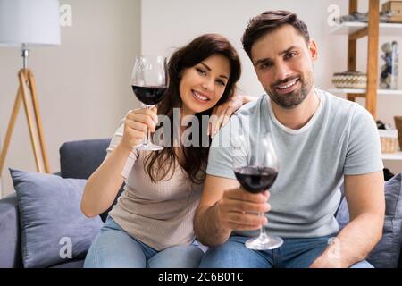 Virtual Wine Tasting Using Laptop. Online Party And Drinks Stock Photo