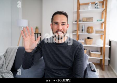 Happy Man On Couch Or Sofa In Living Room Stock Photo