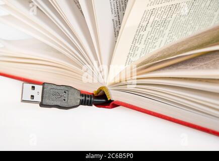 Book with USB cable sticking out Stock Photo