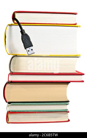 Pile of books with USB cable sticking out Stock Photo