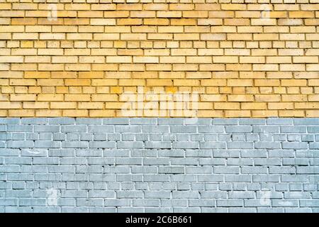 Wall of yellow and gray bricks. Abstract architectural background. Stock Photo