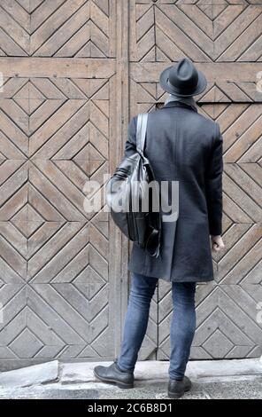 a man stands in front of a closed door Stock Photo