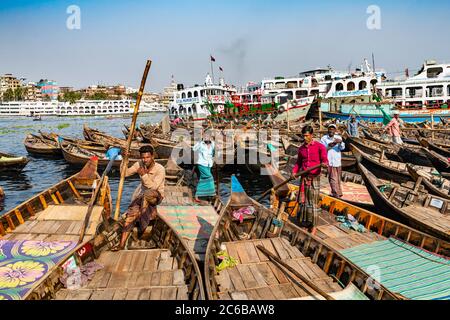 Men in their canoes waiting for new clients, Port of Dhaka, Bangladesh, Asia Stock Photo