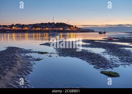 A dusk view across the estuary of the River Torridge from Instow, looking towards the lights of Appledore, in north Devon, England, United Kingdom, Eu Stock Photo