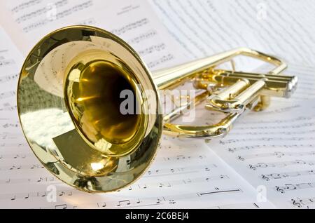 Closeup of trumpet lying on sheet music Stock Photo