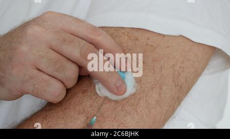 Person Making in His Arm a Vaccine Against Flu, Grippe or Cold, Treatment for the Pandemic of Covid-19 Stock Photo