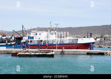 Fishing boat docked in a harbour. Stock Photo