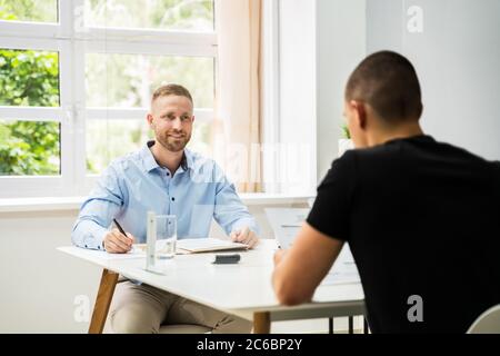 Job Interview Business Meeting At Office With Social Distancing Stock Photo