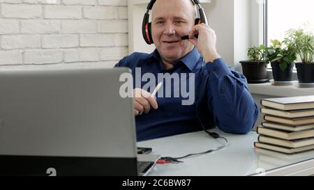 Man Working Remote from Home Using Laptop Connection Stock Photo