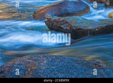 Close up at the water current from Merced River with autumnal foliage from nearby shore bouncing off the water surface, Yosemite National Park, Ca, US Stock Photo