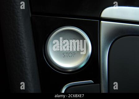 Start engine button. Start stop engine button on a modern car dashboard. Car engine start and stop button. Stock Photo