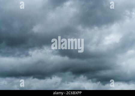 Brooding, moody dark cloud formations. For economic storm clouds, clouds on the horizon, storm clouds gathering, gloomy outlook, silver lining clouds Stock Photo